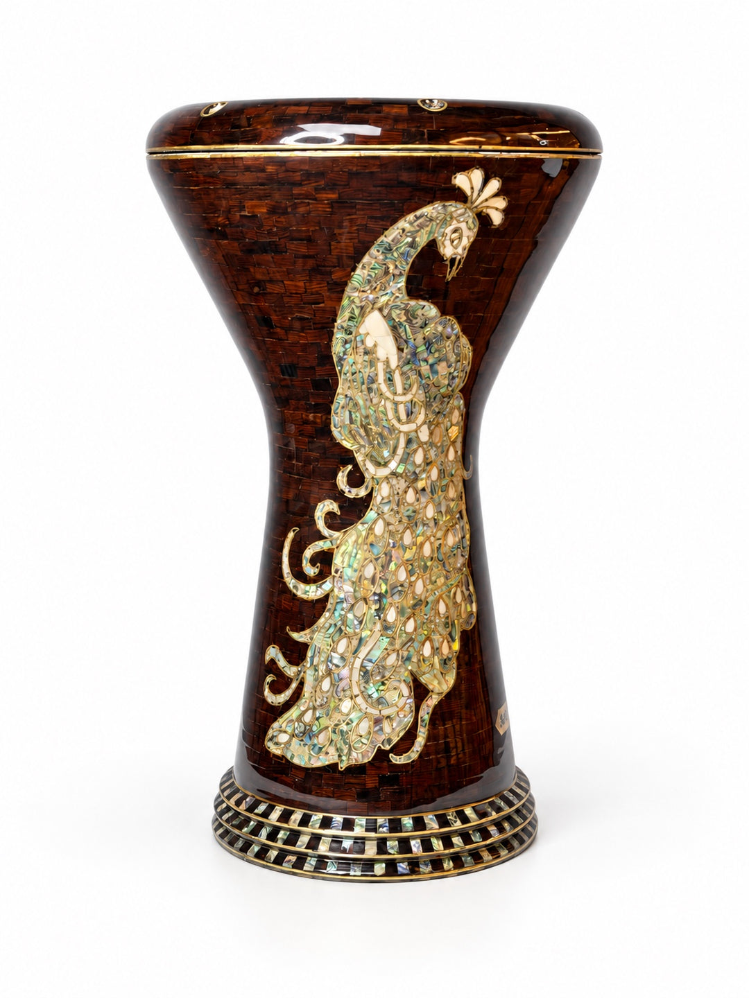 Sala Amber Peacock Sombaty darbuka standing upright, showing a pale peacock motif on a dark amber-brown mosaic background.